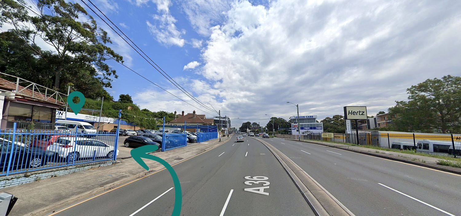 View south down the Princes Highway, Arncliffe — Convertible & Sunroof Autocentre is on the left, opposite the Hertz sign